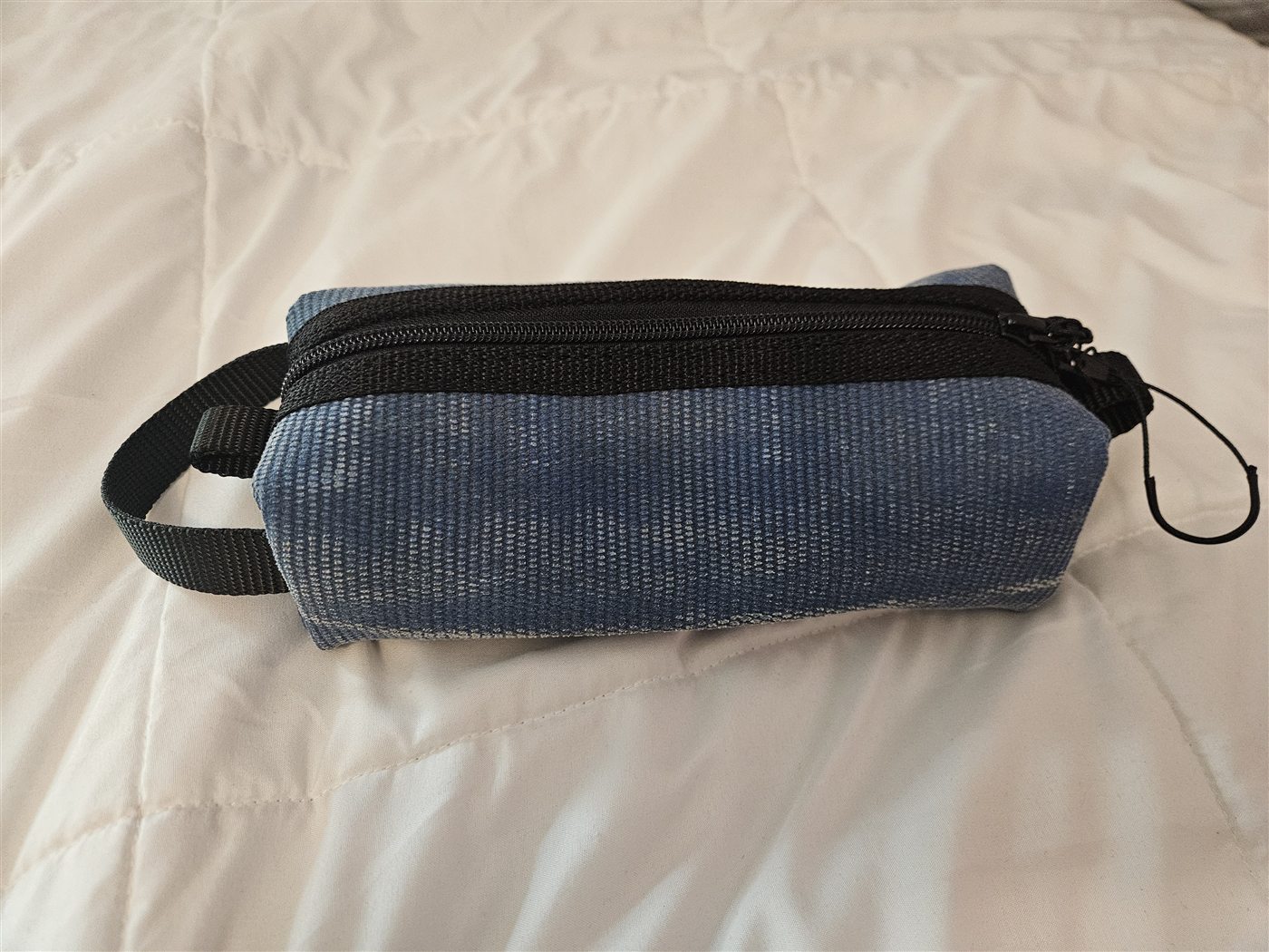 Finished blue dopp kit with black zipper and end tabs